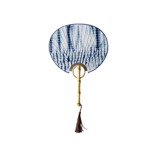Handmade tie-dye fan with natural bamboo handle and flowing patterns on the surface.